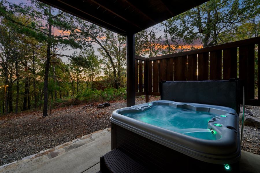 Hot tub on the covered patio, lit at dusk