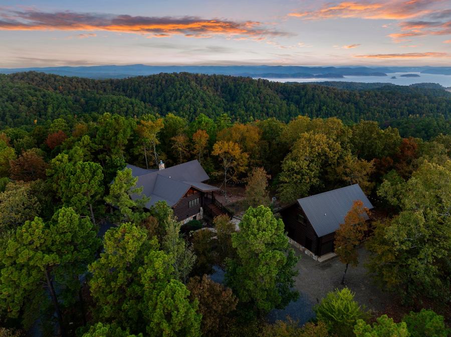 Aerial view of both cabins in fall color with the lake behind